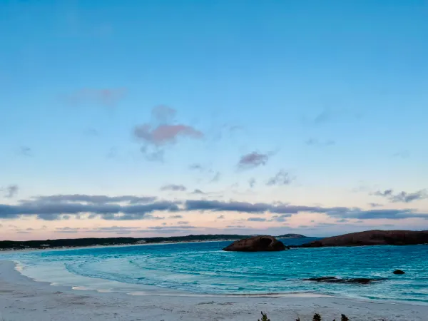 A calm turquoise bay at dusk