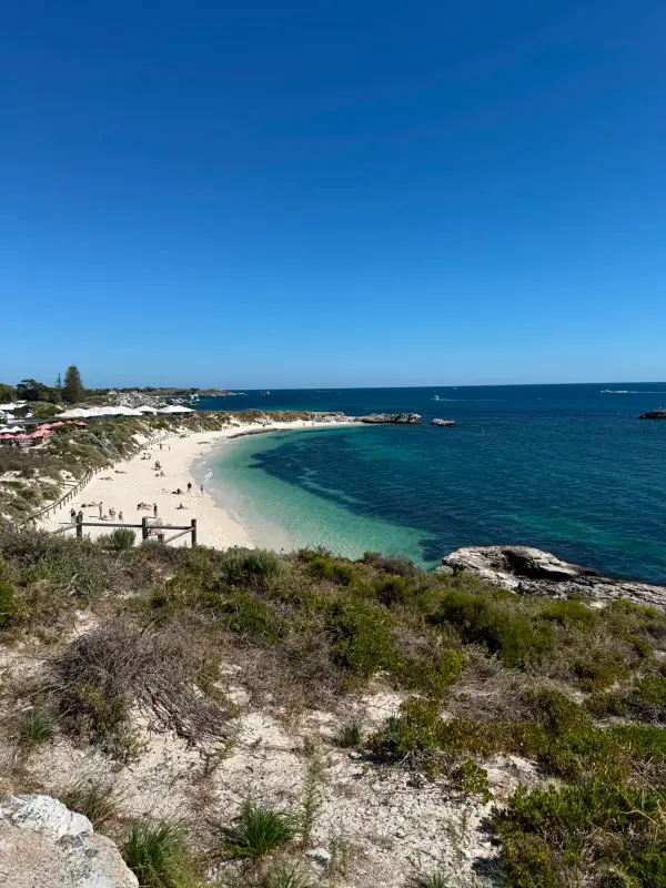 A Western Australian beach and coastline under a clear blue sky